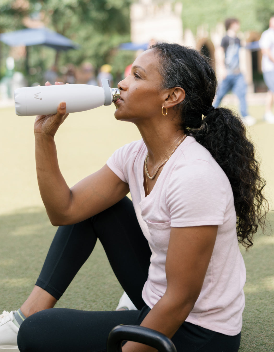 Woman drinking Water.io smart water bottle