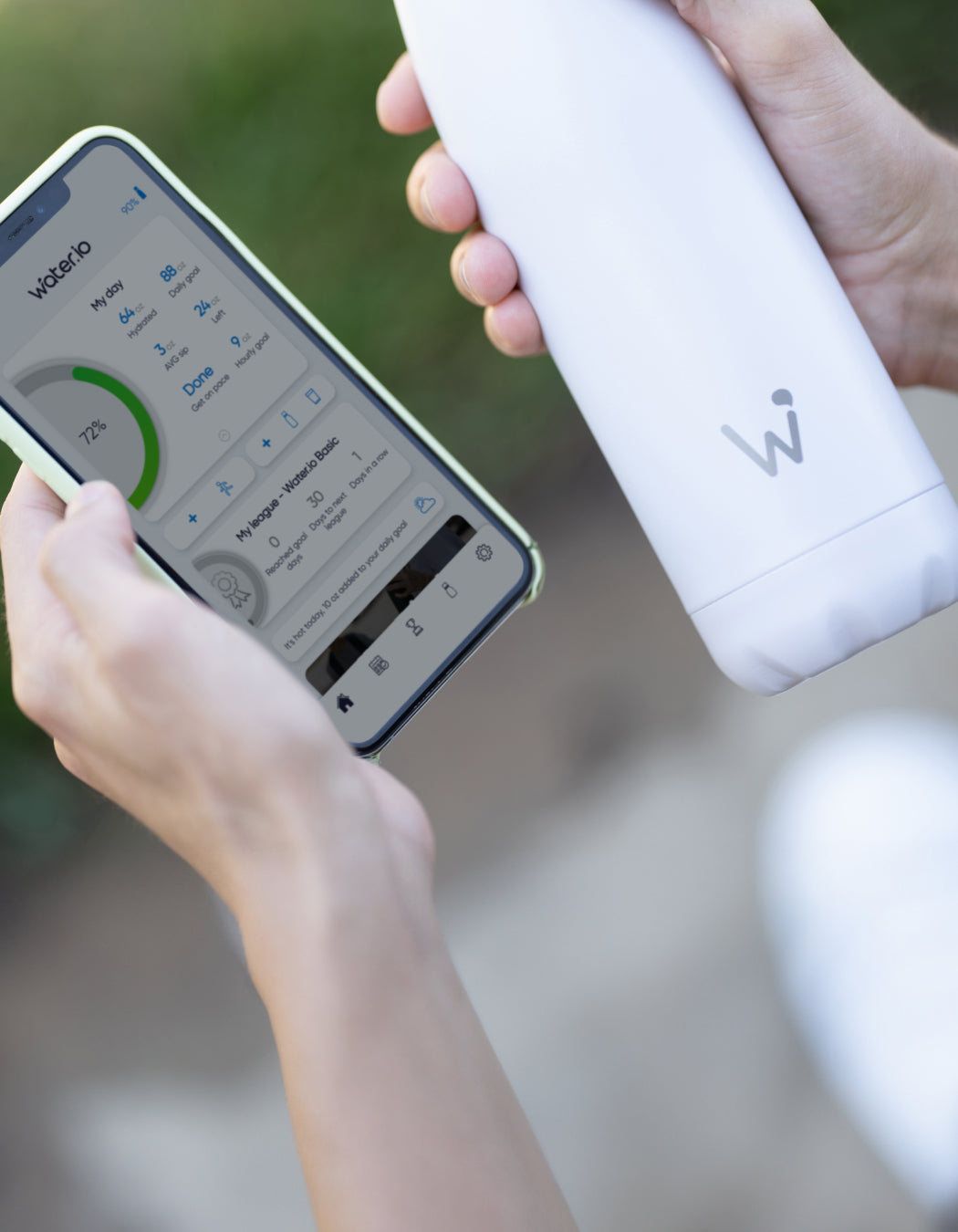Main holding Water.io bottle and using Water.io app