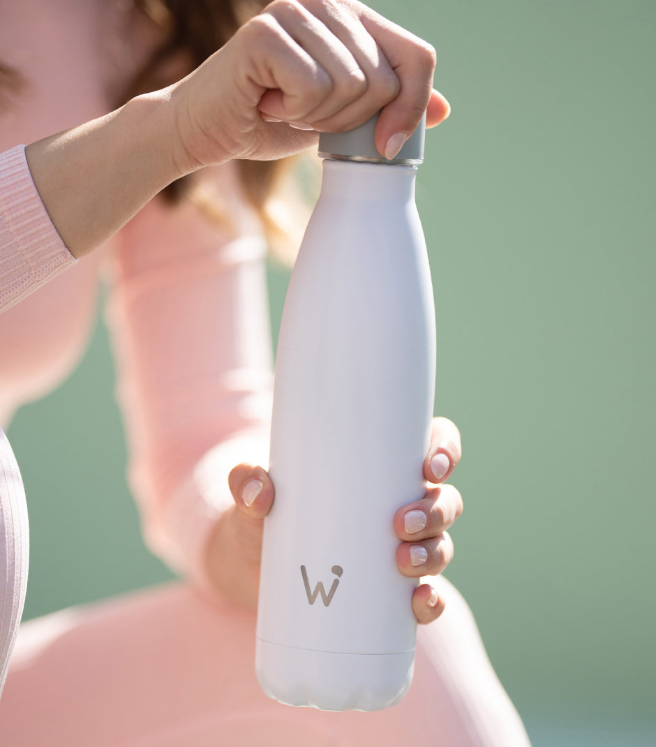 Woman unscrewing top from Water.io bottle