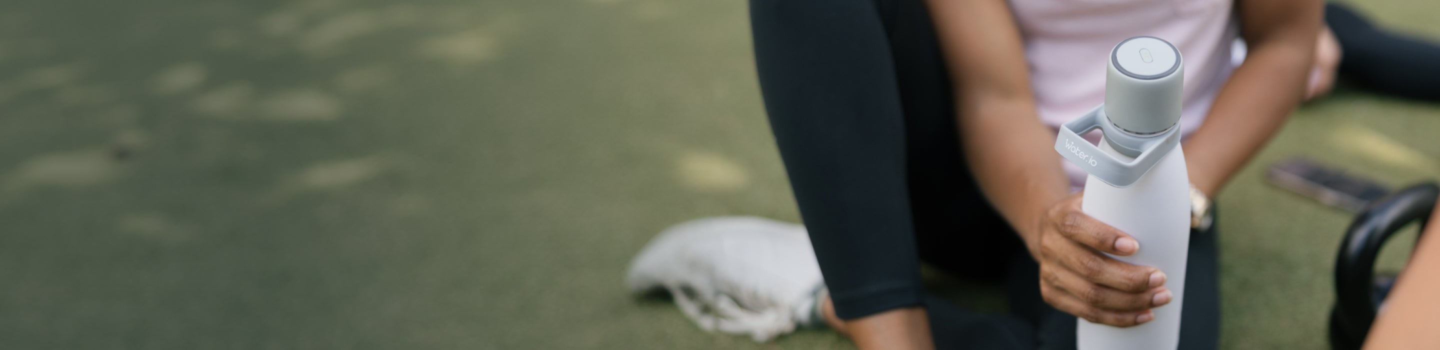 Woman holding Water.io bottle