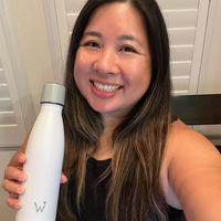 Woman smiling and showing off her Water.io bottle