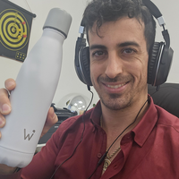 Man working at a computer and holding his Water.io bottle