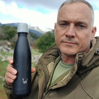 Man out for a hike showing his Water.io bottle