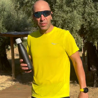 Man outside showing off Water.io bottle